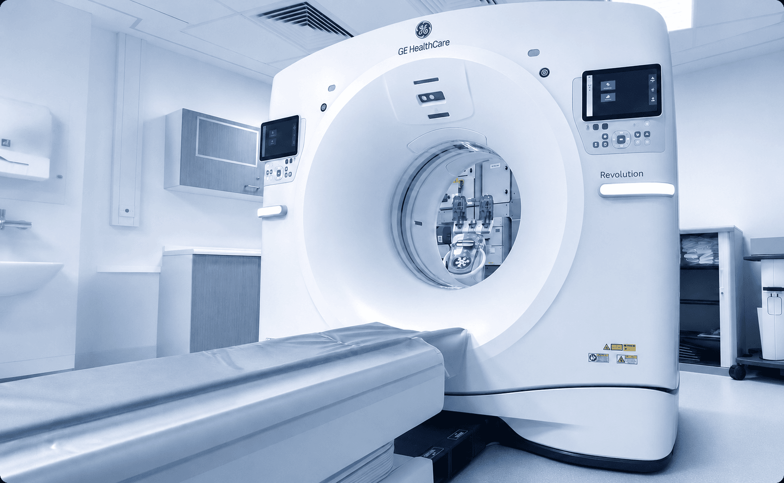 GE Healthcare Revolution CT scanner with contrast injector visible inside the gantry