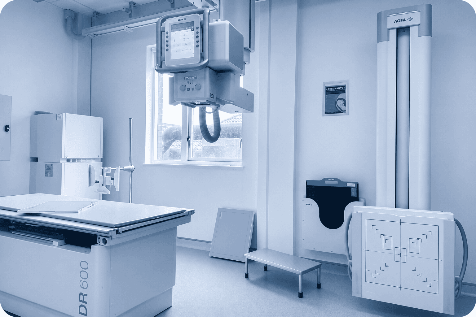 Agfa digital X-ray unit with ceiling-mounted tube positioned above an examination table