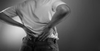 person-with-back-pain-holding-their-lower-back